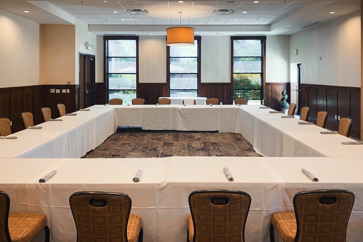 The Maple room set in a hollow square, with wainscot panelling and two windows on the far wall.